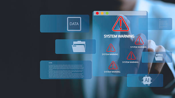 istock A person is pointing at a computer screen that has a warning sign on it 2228821113