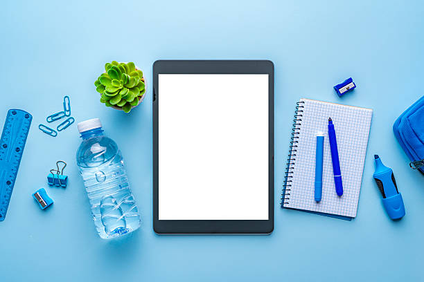 Digital tablet mockup, blank screen device. School or office supplies banner. Blue background, working or studying concept