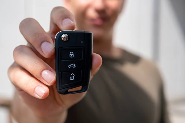 istock A man's hand holding a car key 2228821448