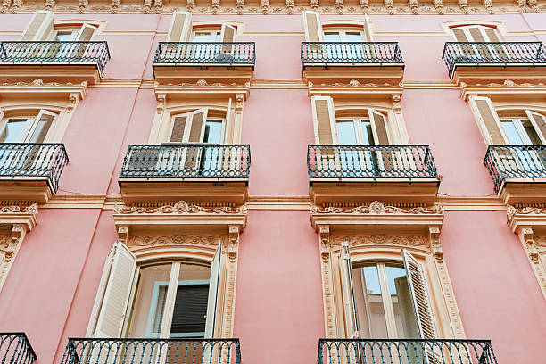 istock Ornate Pink Facade Building With Black Iron Balconies 2228822237