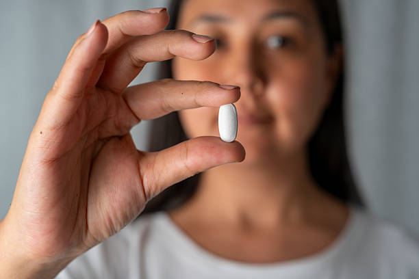 istock Woman hand holding a white pills 2228822608