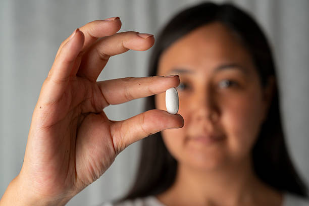 istock Woman hand holding a white pills 2228822631
