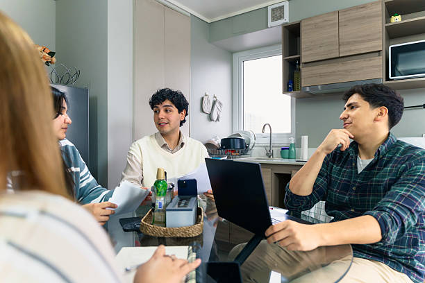 istock Young latin american students collaborating on a project in a modern kitchen 2228825525