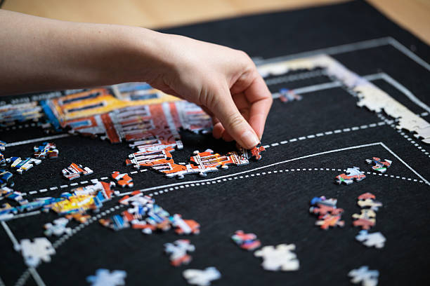 istock Female hand solving jigsaw puzzle close up 2228828227