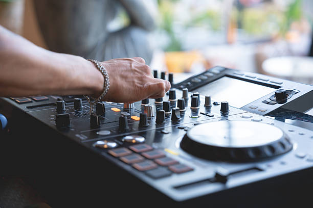 istock DJ Hands creating and regulating music on dj console mixer in concert 2228829516