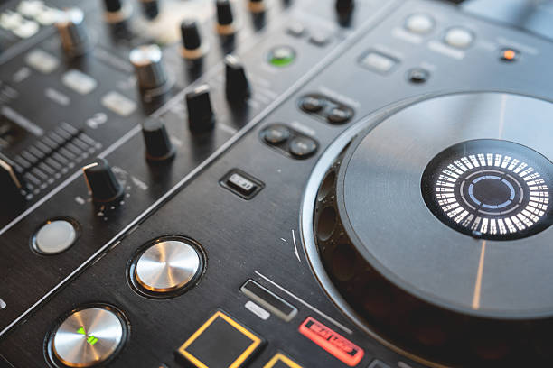 istock DJ Hands creating and regulating music on dj console mixer in concert 2228829561