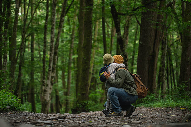 istock Parent and Child Enjoying Nature in a Serene Forest Setting 2228834461