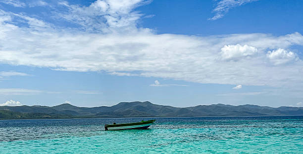 istock Boat on Calm Water with Mountain Backdrop 2228834601