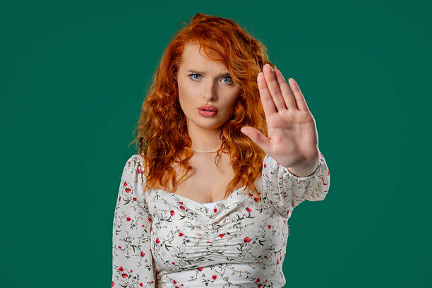 istock Ginger woman with open palm in stop gesture, clear assertive body language 2228834616