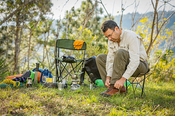 istock Senior man setting up shoe laces outdoors in the wilderness 2228838715
