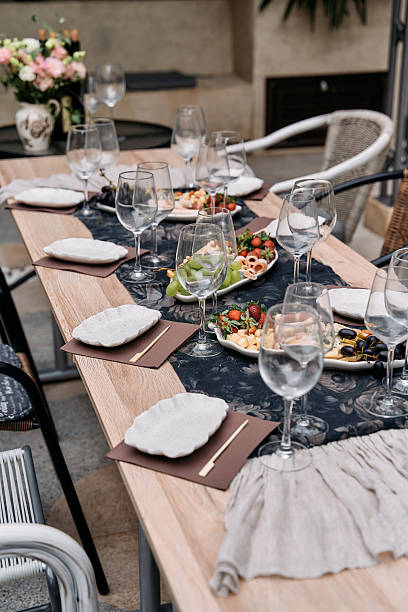 istock Elegantly Set Dining Table Featuring Gourmet Cuisine, Stylish Tableware, and Beautiful Floral Arrangement for Memorable Gatherings and Celebrations 2228841768