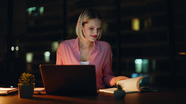 istock Smiling developer working late at laptop in lamp light closeup. Inspired woman 2228842450