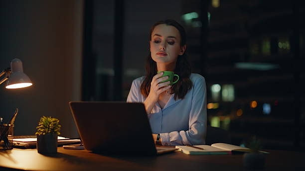 istock Freelancer relaxing night workplace drinking coffee closeup. Relaxed woman break 2228843122