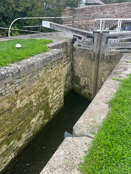 istock Old Canal Lock Gate With Water Flowing and Rustic Wooden Structure 2228845766