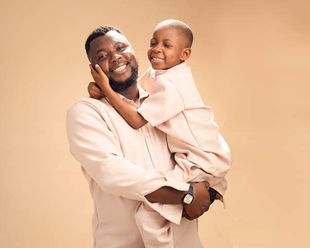 istock Happy African father holding son in warm studio embrace 2228849579