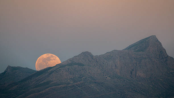 istock Full Moon Rising Behind Mountain Ridge at Dusk – Series 1/4 2228850190
