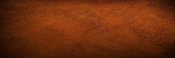 istock Black dark red brown burnt orange rough grunge texture background. Toned concrete wall surface. Close-up. Space for design. Wide banner. Panoramic. 2228850209