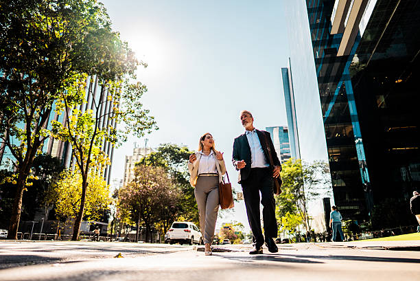 istock Coworkers talking while walking in the street 2228852114