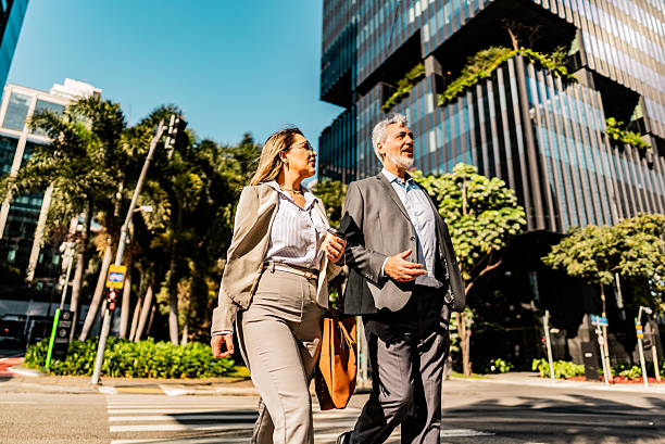istock Coworkers talking while walking in the street 2228852158