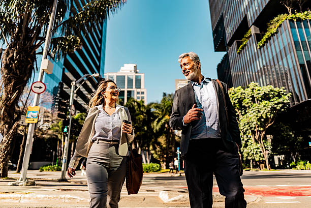 istock Coworkers talking while walking in the street 2228852171