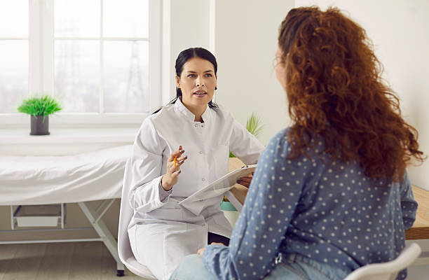 istock General practitioner who works at clinic is asking woman questions about her health problems 2228853867
