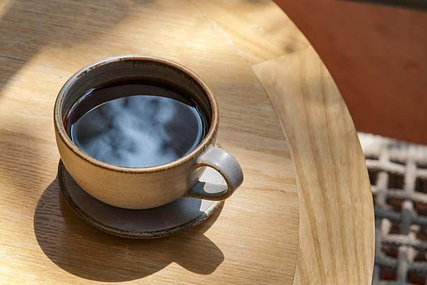 istock hot black coffee on the wooden table at cafe 2228857013
