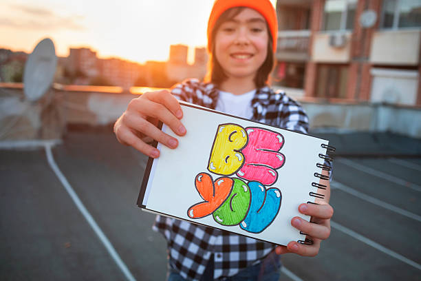 istock Child smiling behind colorful “be you” message 2228857509