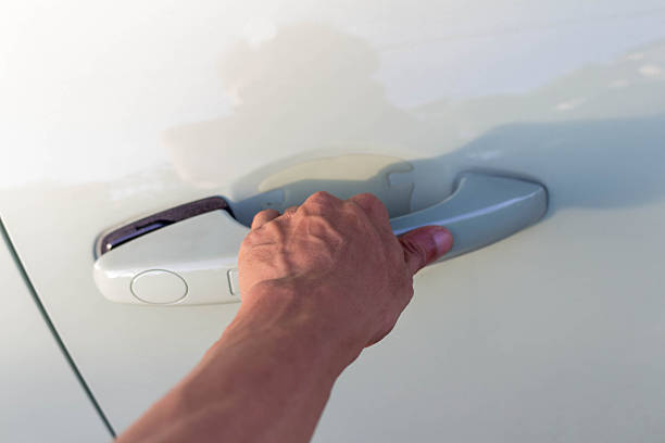 istock Man's Hand Opening Green Car Door 2228861405