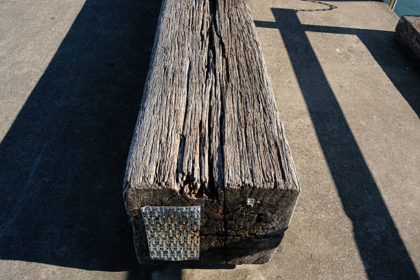 Old wooden beam now used as a bench on a sunny day.