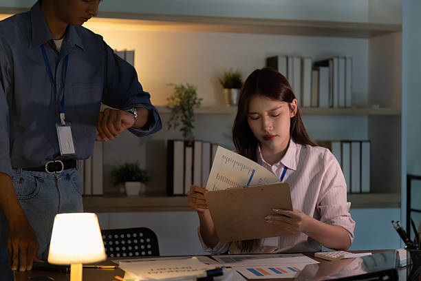 istock Time Management in Office. Professional checking watch while reviewing documents. 2228868478