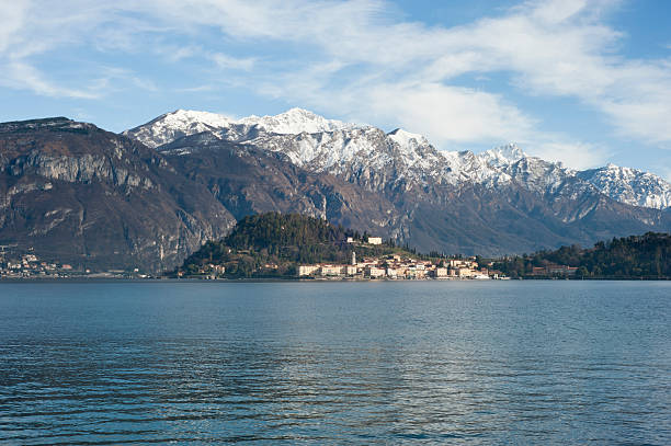 Scenic Lake Como town at water edge with snowy mountain backdrop