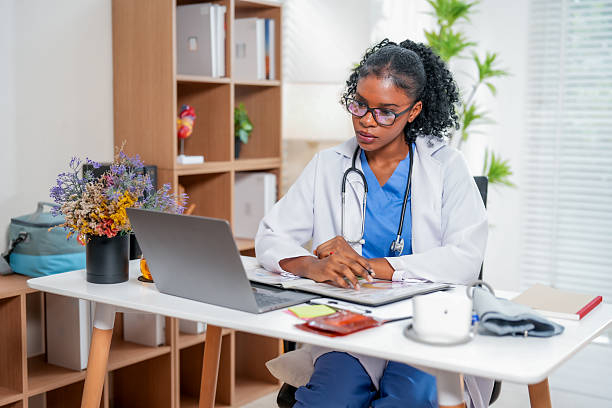 istock Young Black Woman Doctor Concentrating on Important Documents 2228872101