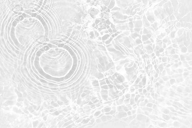 istock White water with ripples on the surface. Defocus blurred transparent white colored clear calm water surface texture with splashes and bubbles. Water waves with shining pattern texture background. 2228874391