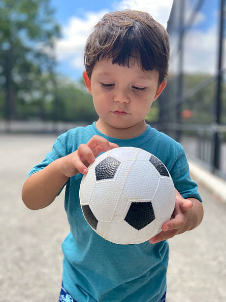 istock Boy playing with soccer ball 2228874413