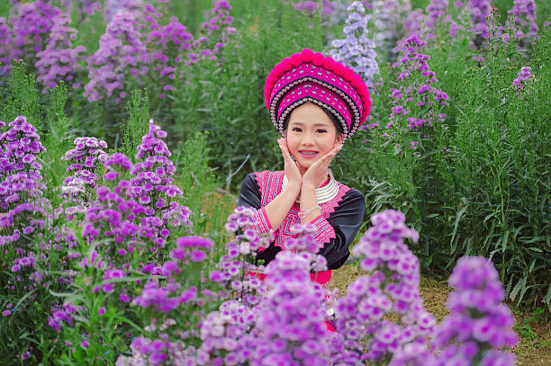 Cute Hmong girl, in a flower garden, cute portrait for background, Chiang Mai, Thailand.