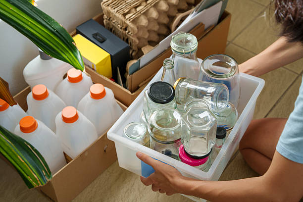 istock Woman Practicing Sustainable Living by Sorting Recyclable Items 2228879210