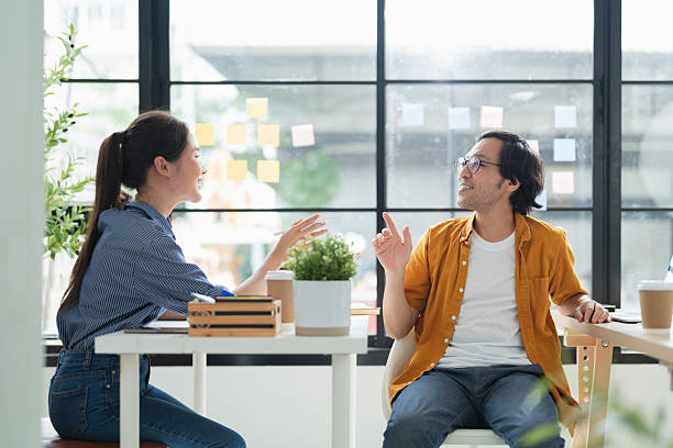 istock business development teamwork is standing and discussing a new rebranding and strategy. The two business people focus on the future target market and present success, using market research data 2228880734