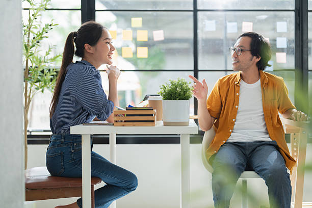 istock business development teamwork is standing and discussing a new rebranding and strategy. The two business people focus on the future target market and present success, using market research data 2228880801