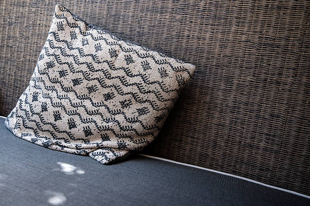 istock linen cushion on a wicker sofa - comfort and relaxation concept with copy space 2228882920