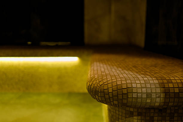 Interior of a hammam sauna with stone finishing and lighting. Spa or sauna relaxation room interior design.