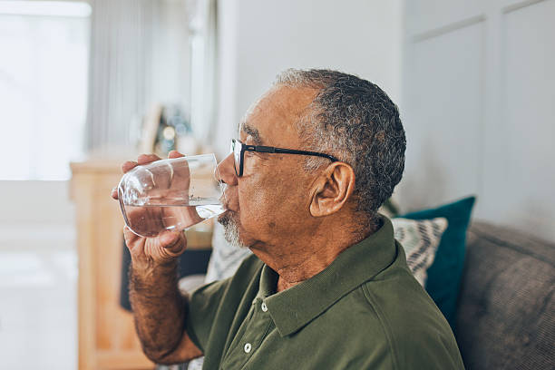 istock Side view of a senior man drinking water from a glass 2228883194