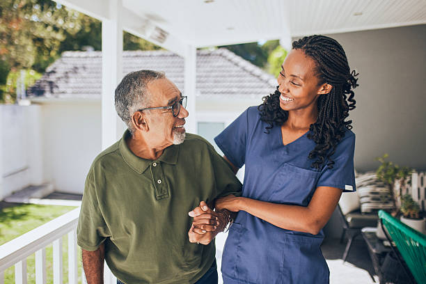 istock Young black female nurse assisting senior man 2228883236