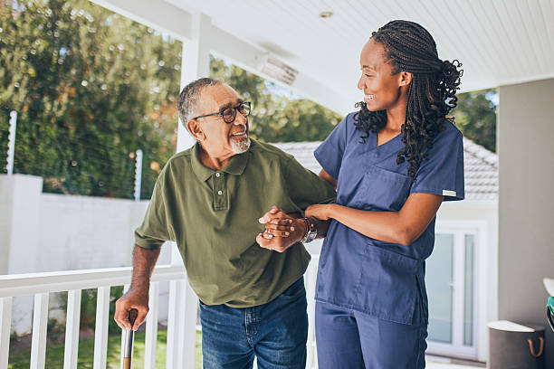 istock Young black female nurse assisting senior man with cane 2228883237
