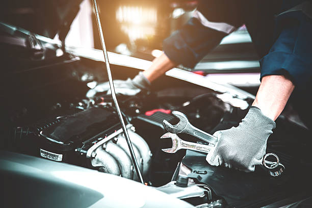 istock Car care maintenance and servicing, Close-up hand technician auto mechanic using the wrench to repairing change spare part car engine problem and car insurance service support. 2228883594
