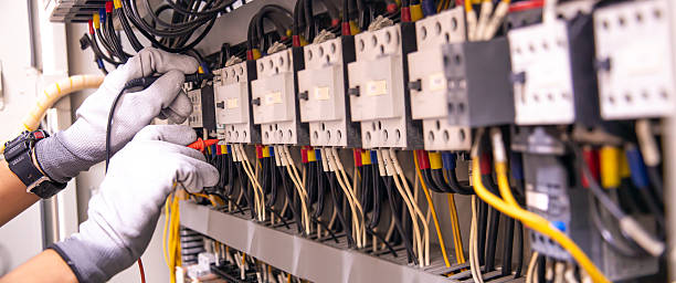 istock Electricity and electrical maintenance service, Engineer hand holding AC voltmeter checking electric current voltage at circuit breaker terminal and cable wiring main power distribution board. 2228884200
