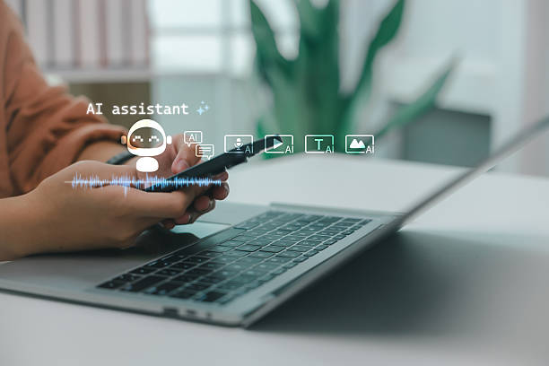 istock Close-up of hands using smartphone with AI assistant interface, voice wave and icons representing chat, voice, video, text, and image generation in modern digital workspace. 2228886603