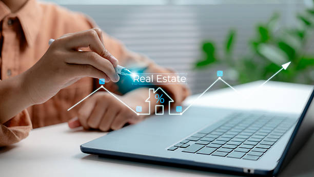 istock Hand analyzing real estate investment trends with digital interface on laptop, showing housing market growth, property value, interest rates, and smart investment technology. 2228886606