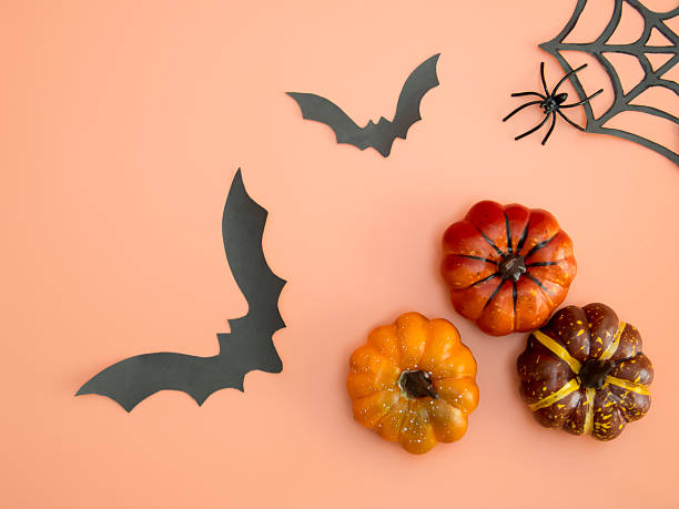 istock Decorative Halloween orange backdrop featuring pumpkins, bats, a skeleton hand, and candy corn 2228886683