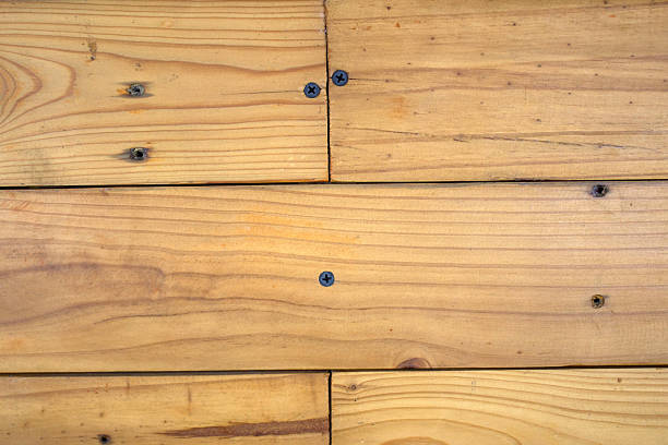 Close-up of natural wooden planks with screws, horizontal alignment. Ideal for background, texture, or design mockups.