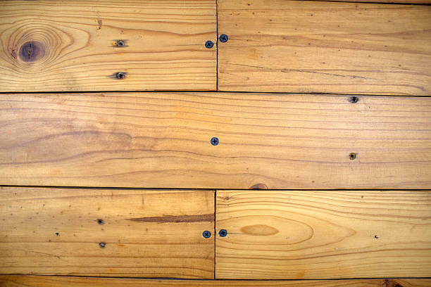 Close-up of natural wooden planks with screws, horizontal alignment. Ideal for background, texture, or design mockups.